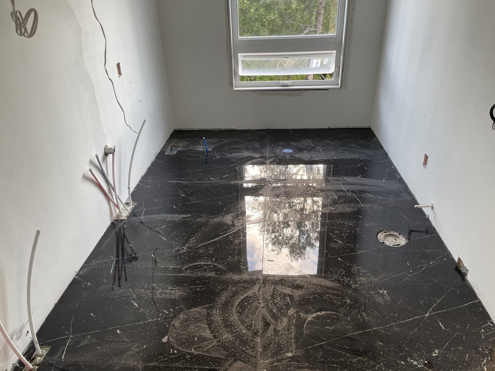 Bathroom floor tile at rough-in stage — Berm Inc. project photo