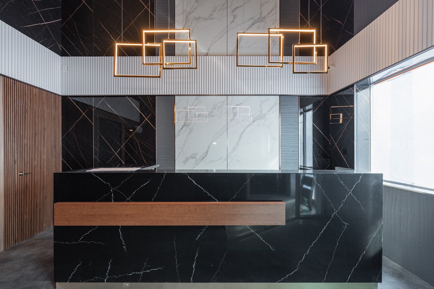 Commercial lobby with marble reception desk — Berm Inc. project photo
