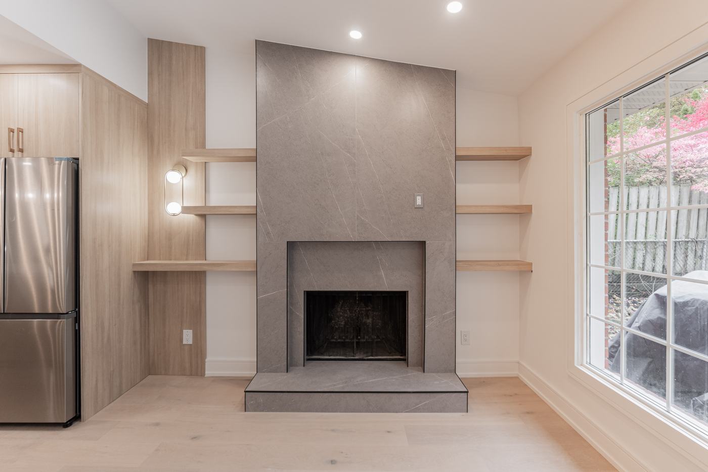 Fireplace feature wall with built-in shelving — Berm Inc. project photo