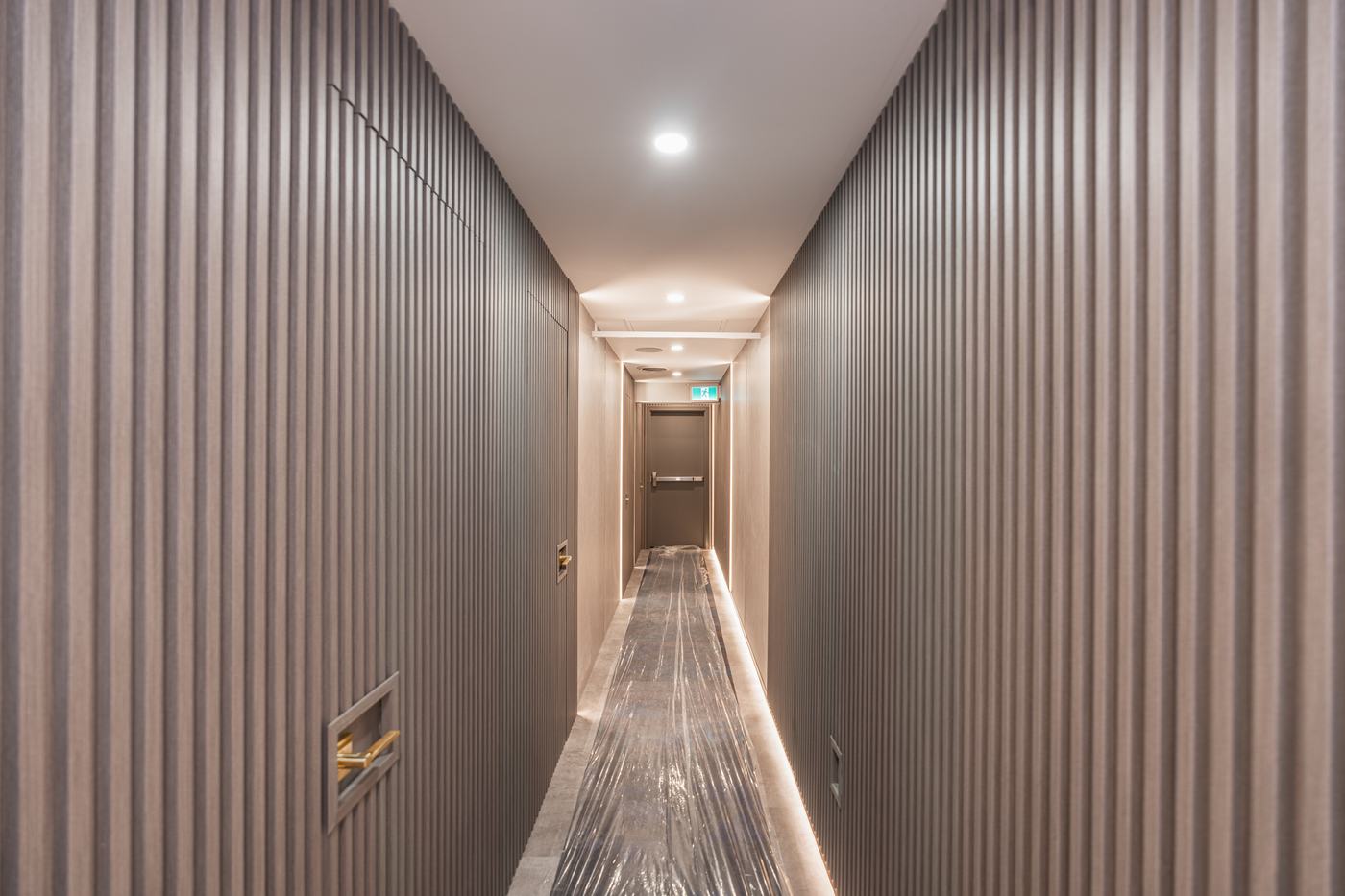 Commercial hallway with fluted wall panels — Berm Inc. project photo