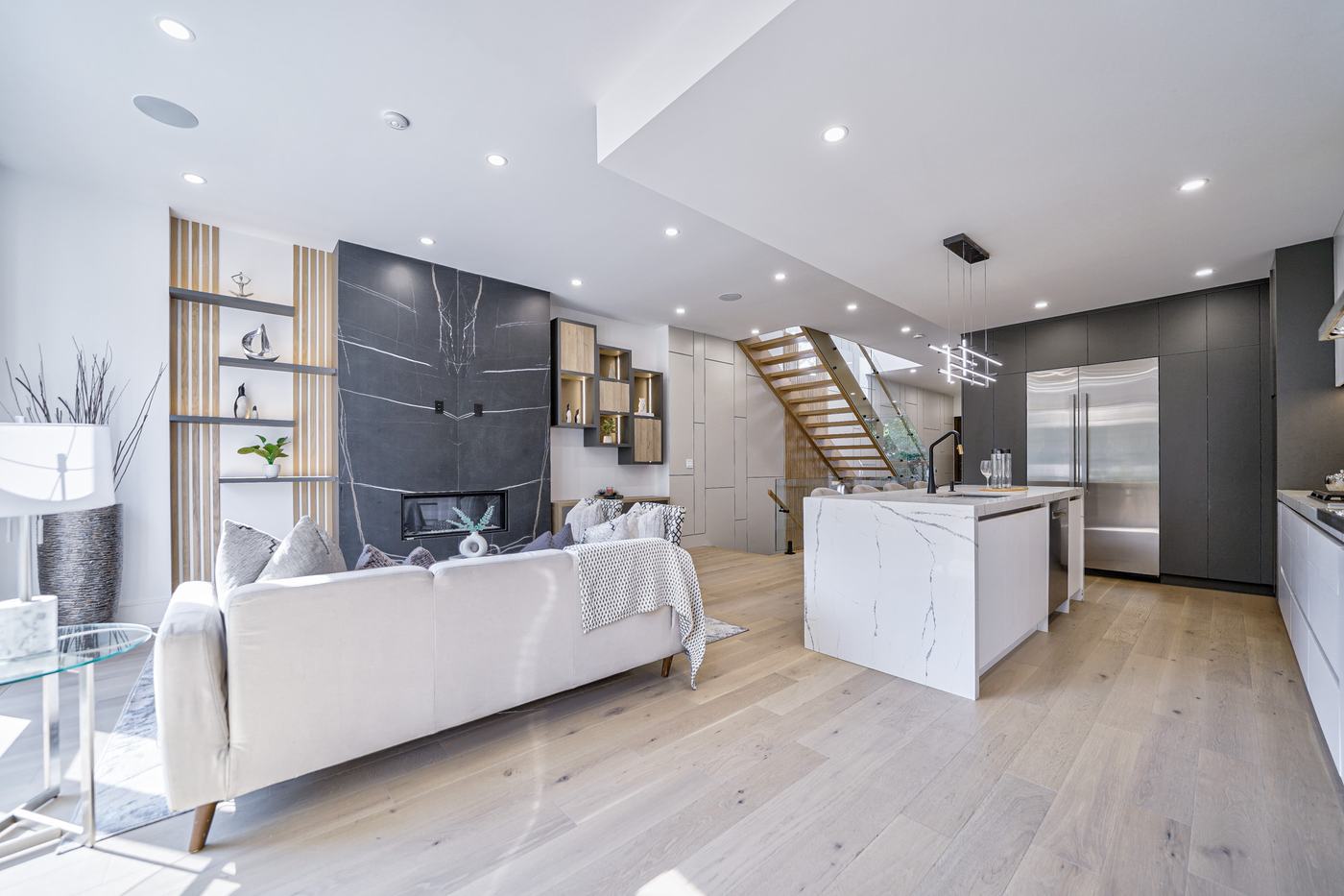 Open-concept living room and kitchen in a Berm Inc. custom home