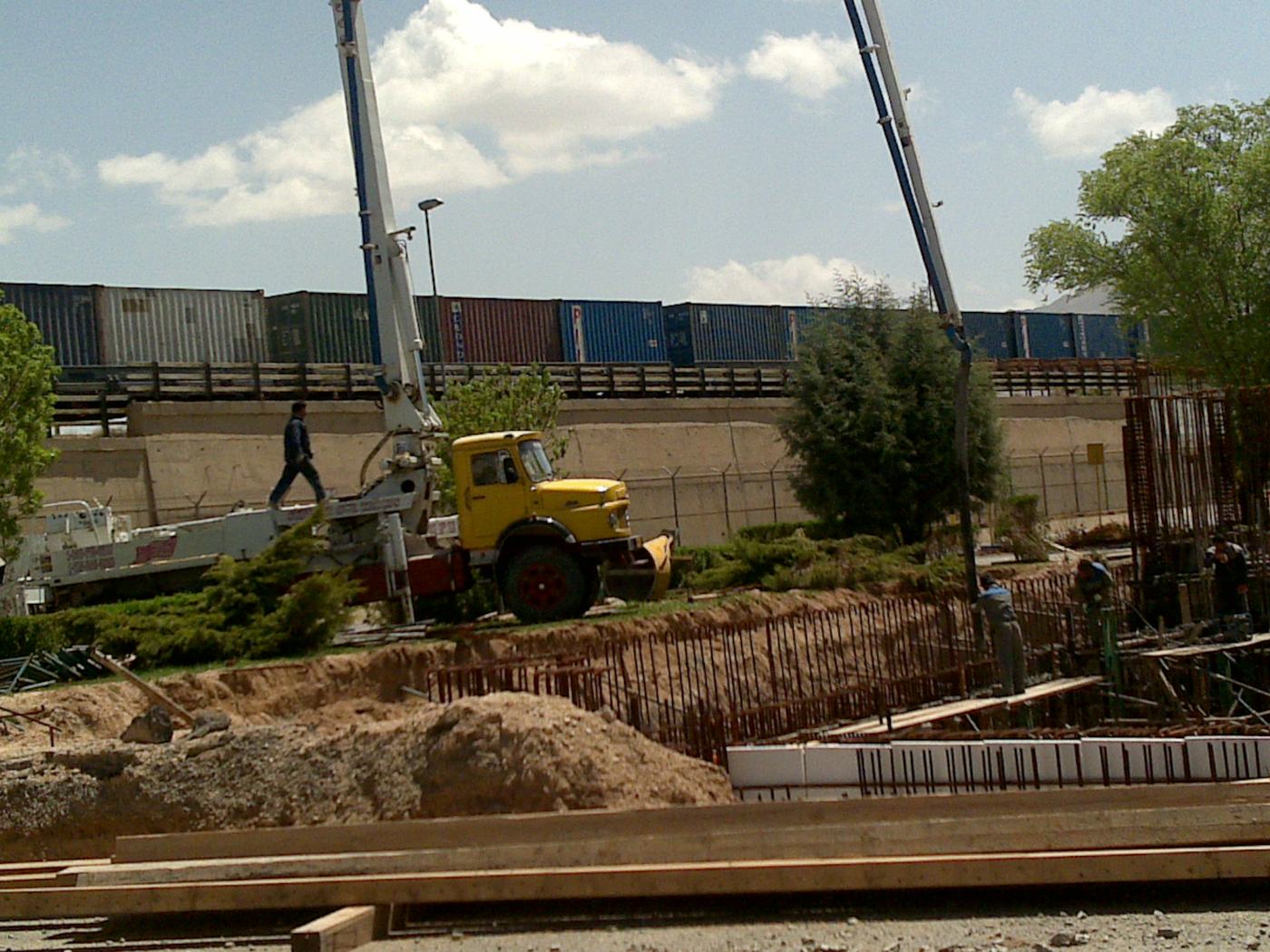 Concrete boom pump placing foundation concrete — Berm Inc. project photo